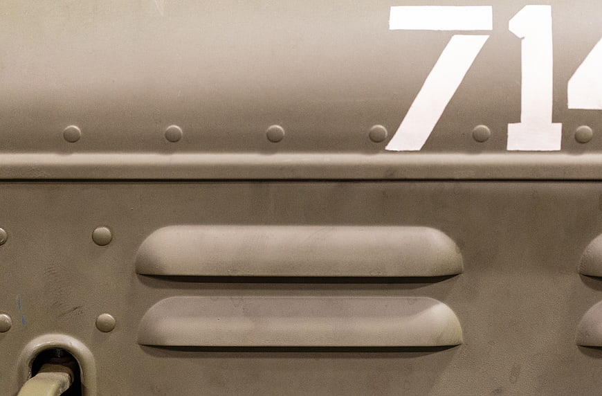 Close-up of vintage military tank armor with rivets and number 71
