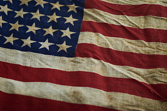 Close-up of vintage weathered American flag fabric texture