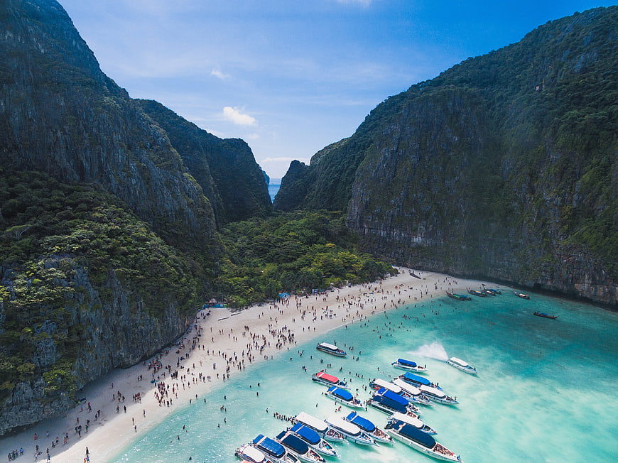 Aerial view of Maya Bay with long-tail boats and tourists