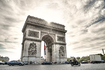 Arc de Triomphe Paris with dramatic sky and traffic