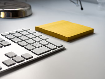 Modern office desk with calculator and yellow sticky notes