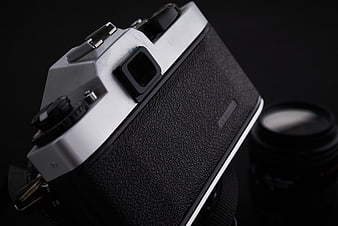 Close-up of vintage film camera on black background