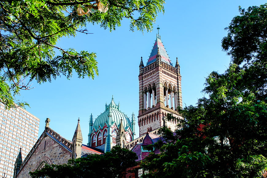 Historic Gothic Church Tower Framed by Green Trees