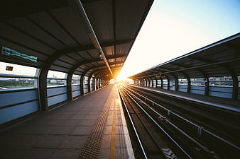 Empty Train Station Platform at Sunset with Golden Sunlight