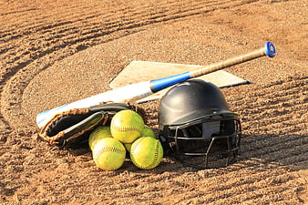 Softball equipment on dirt field near home plate