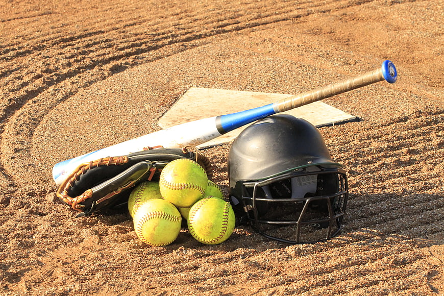 Softball equipment on dirt field near home plate