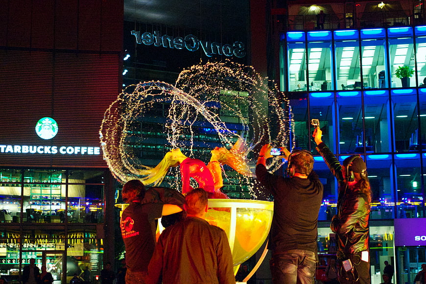 Nighttime water fountain performance at Sony Center Berlin