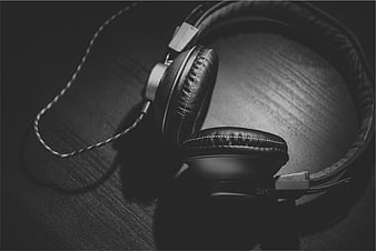 Black and White Vintage Headphones on Wooden Surface