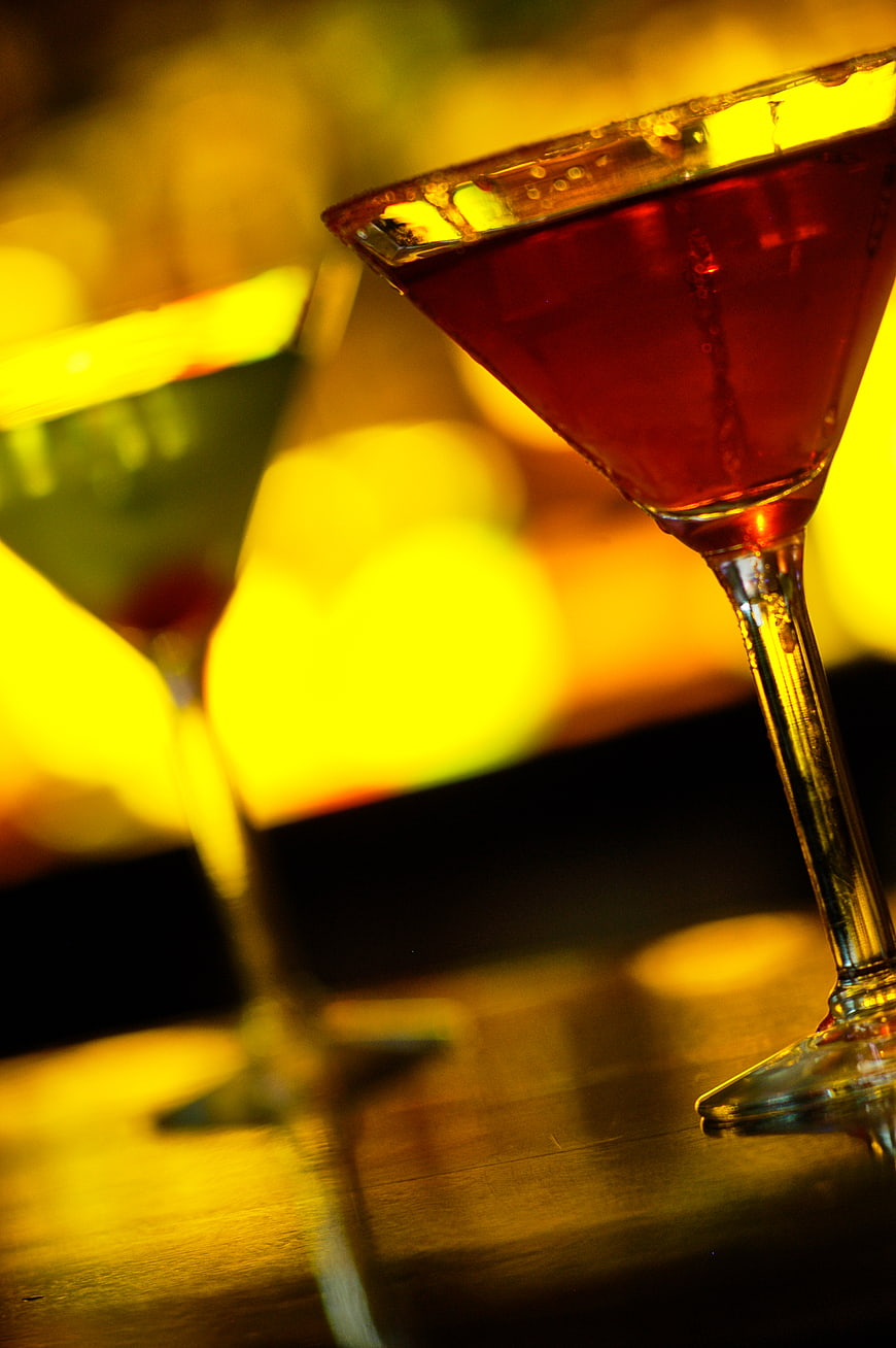 Close-up of red cocktail in martini glass with bokeh background