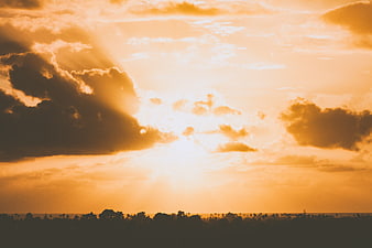 Dramatic Golden Sunset Sky with Sunbeams and Silhouette