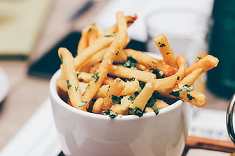 Gourmet French Fries with Herbs in White Bowl