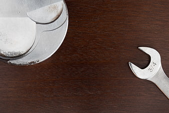 Wrench and Piston on Wooden Surface with Copy Space
