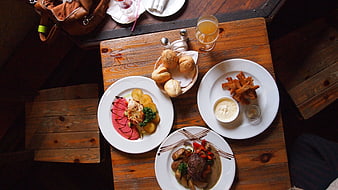 Overhead view of restaurant meal with steak, salmon, and fries