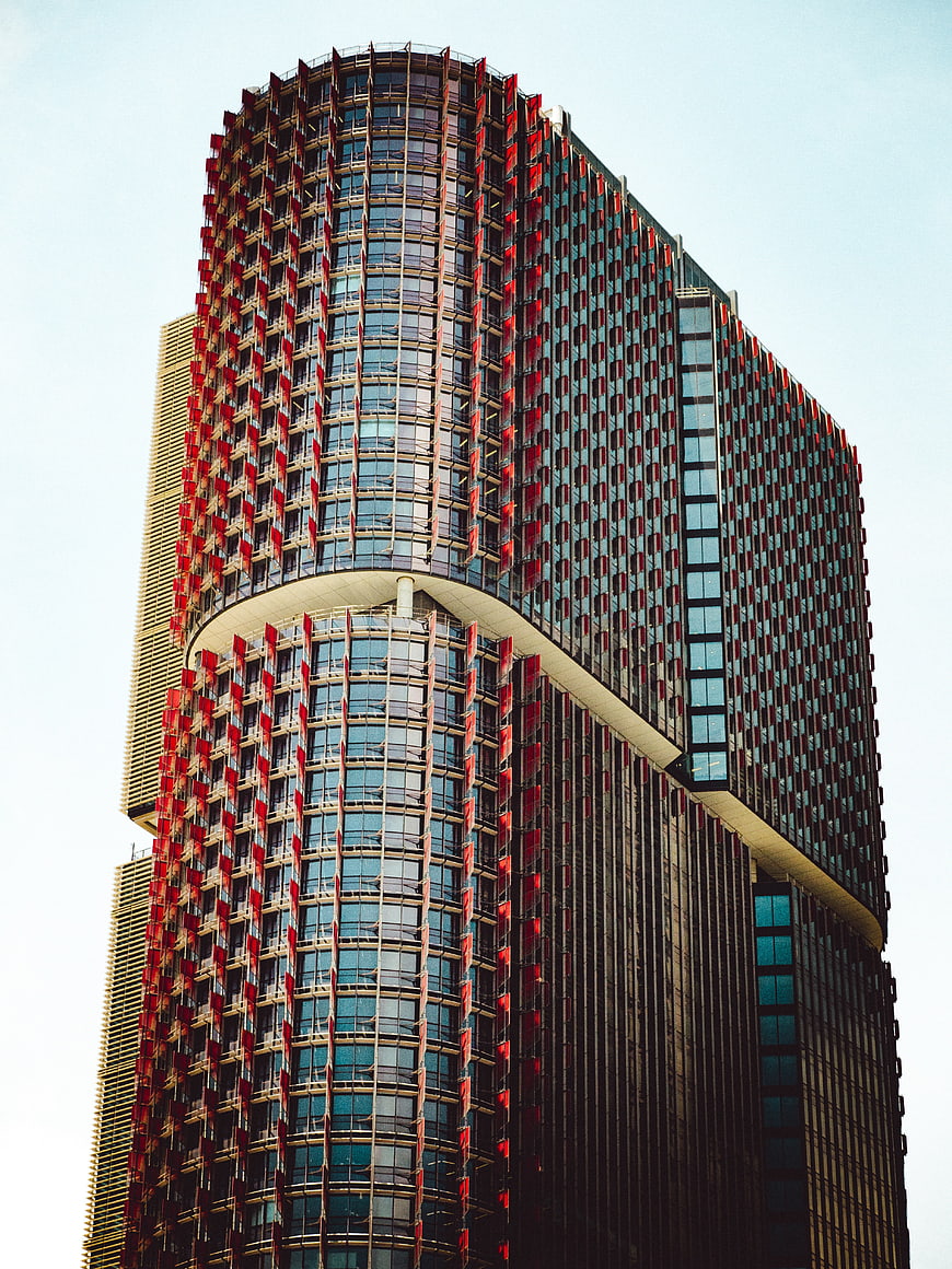 Modern skyscraper with red and blue glass facade