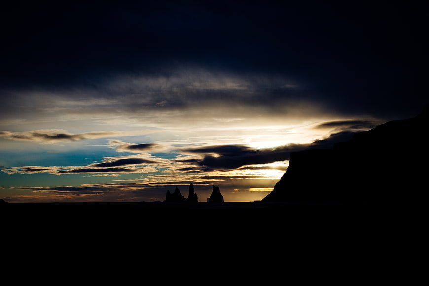 Dramatic Silhouette of Sea Stacks Against Golden Sunset Sky