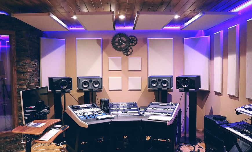 Modern Recording Studio with Mixing Console and Purple Lighting