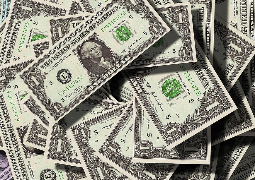 Scattered One Dollar Bills with Dramatic Shadows