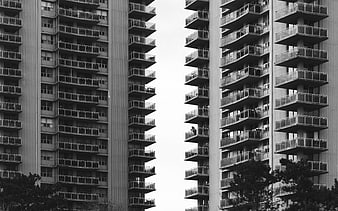 Black and white symmetrical view of modern apartment balconies