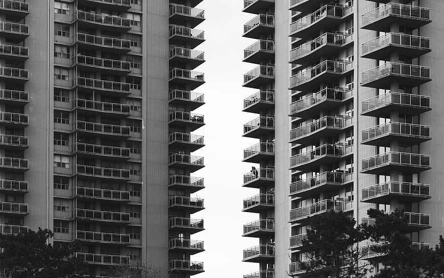 Black and white symmetrical view of modern apartment balconies