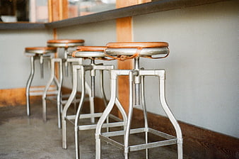 Industrial metal bar stools with leather seats in a row