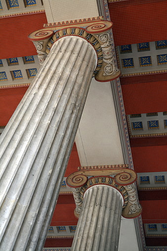 Low angle view of ornate Ionic columns and tiled ceiling