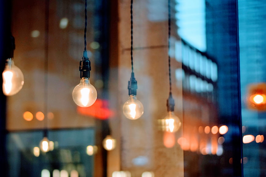 Vintage Edison light bulbs hanging in a cafe window