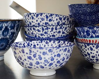 Stacked blue and white floral ceramic bowls on table