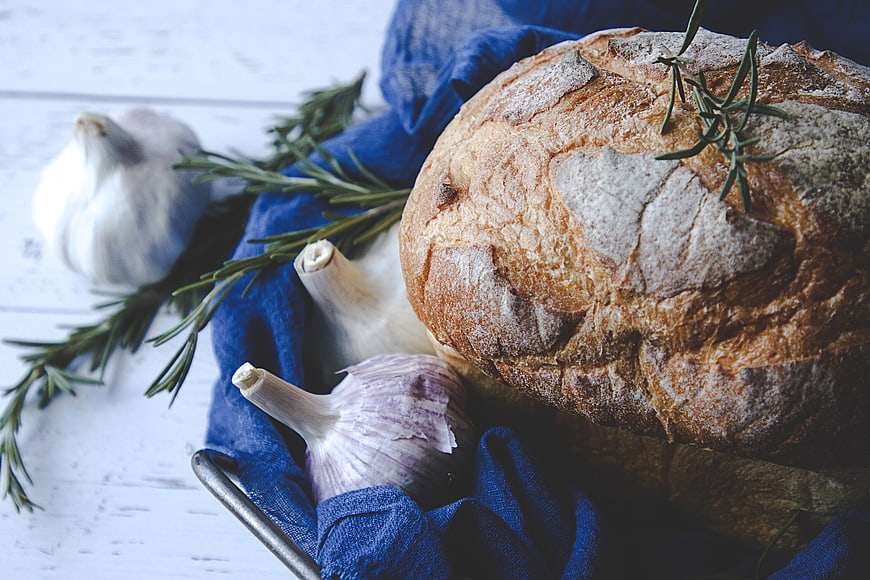 Rustic sourdough bread loaf with garlic and rosemary