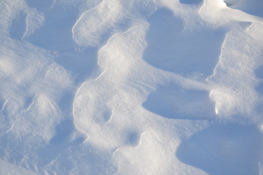 Abstract white snow texture with blue shadows