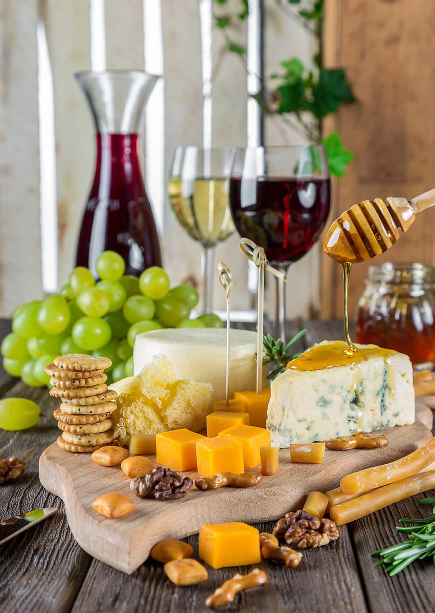 Artisanal Cheese Board with Wine, Grapes, and Honey