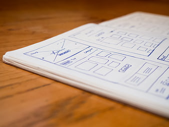 Hand-drawn wireframe sketches on notebook paper