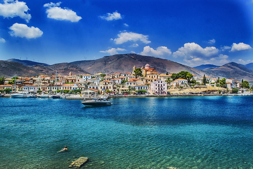 Scenic coastal village with turquoise sea and mountains