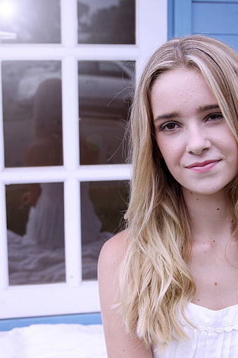 Close-up portrait of smiling blonde woman outdoors
