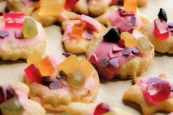 Colorful decorated cookies with gummy candies and heart sprinkles