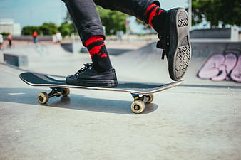 Skateboarder performing trick at outdoor skatepark
