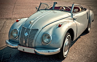 Vintage Light Blue Convertible Car on Cobblestone Street