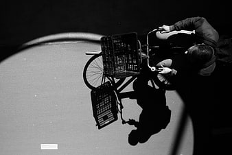 High angle black and white photo of cyclist with cargo bike