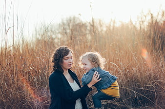 Mother and Toddler Playing in Golden Grass Field