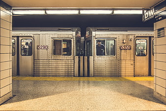 Symmetrical view of two subway trains at a station platform