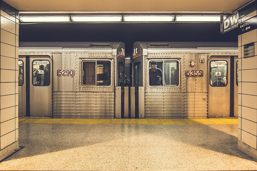 Symmetrical view of two subway trains at a station platform