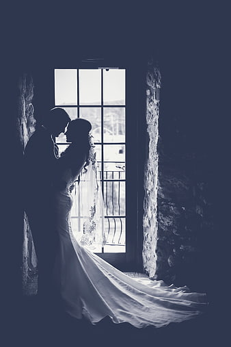 Silhouette of Bride and Groom in Front of Window