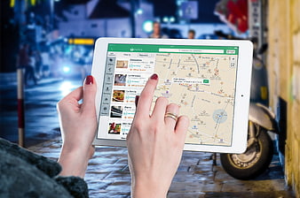 Woman using restaurant app on tablet at night