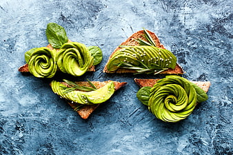 Avocado toast art on blue textured background
