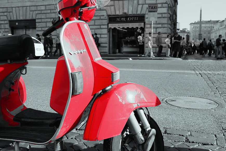 Red Vespa Scooter in Black and White City Street