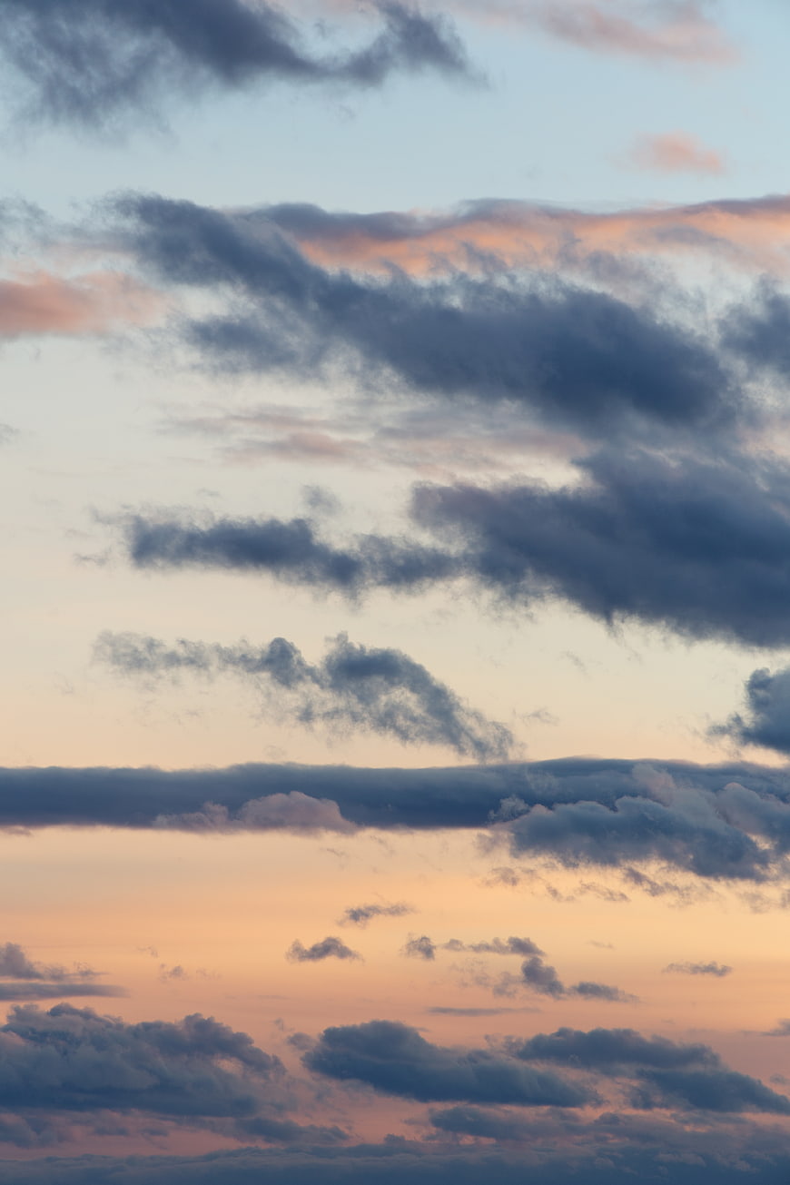 Dramatic sunset sky with layered clouds and pastel colors