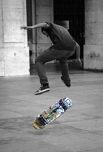 Skateboarder performing trick with selective color effect