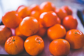 Close-up of fresh tangerines with vibrant orange texture