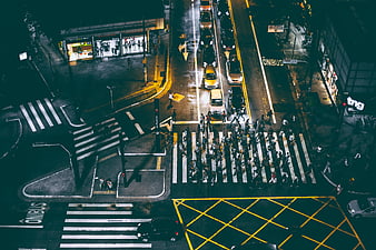 Aerial Night View of Busy Urban Intersection with Pedestrians