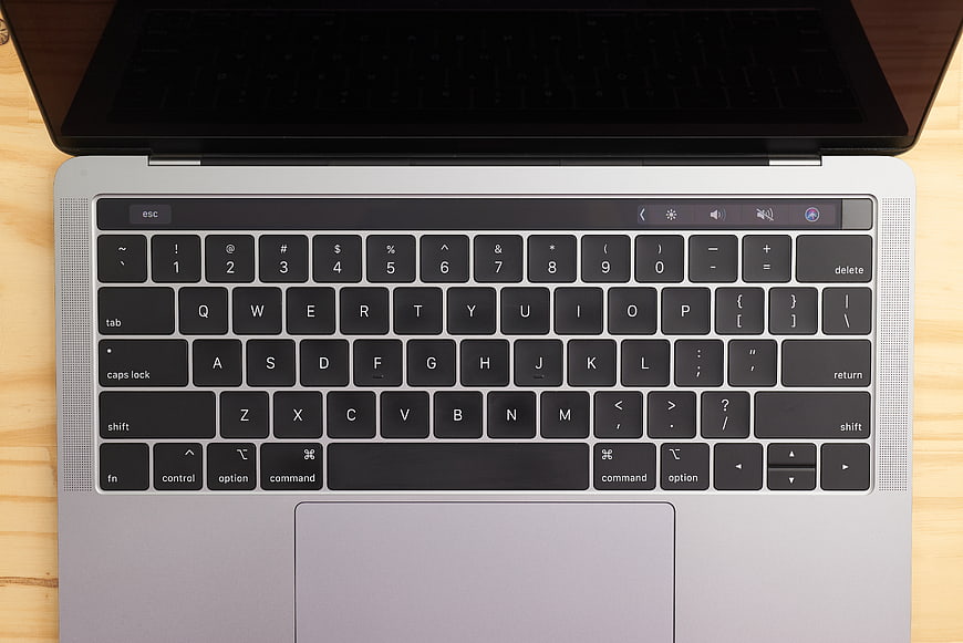 Top View of Silver Laptop Keyboard on Wooden Desk