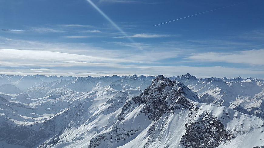 Snow-Covered Mountain Peaks Under Blue Sky